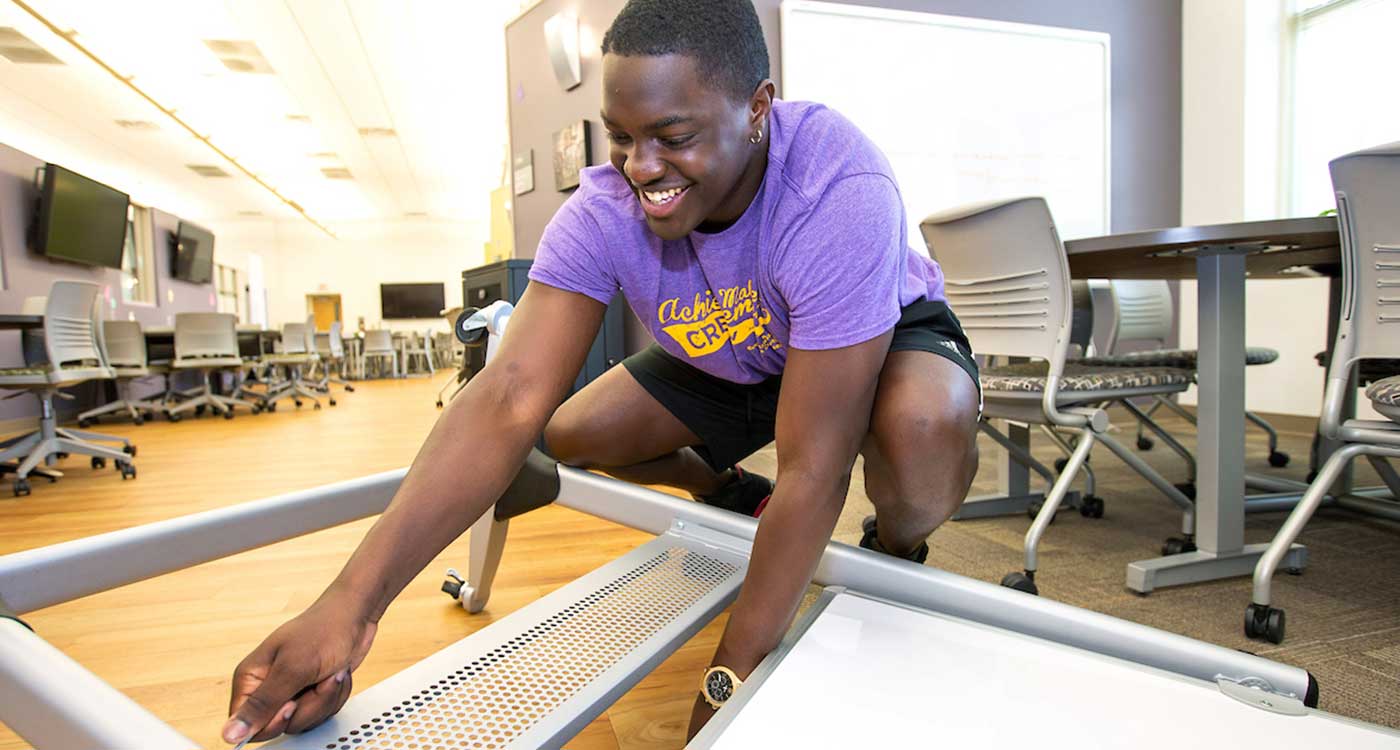 ECU student Davarion David puts together a smart board at the Pirate Academic Success Center on Wednesday.