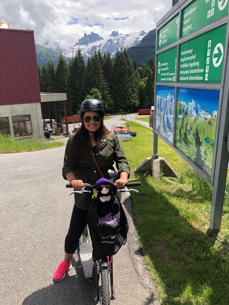 Clark suits up with her helmet to drive down the mountain on a scooter.