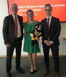 Maria Miller, center, poses with PeeDee at The Swiss Bankers Association in Basel.