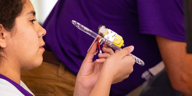 Andrea RayoSoto builds a robot during STEM camp. (Photos by Cliff Hollis)