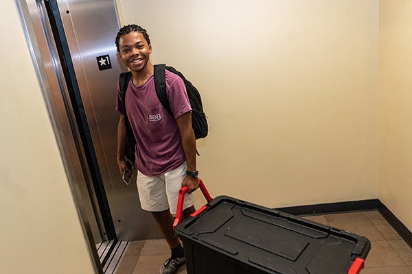 Saiid Powers, a sophomore at ECU, boards the elevator in College Hill Suites during move-in.