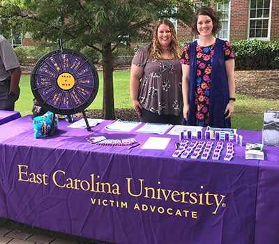 Brittany Egan, left, and Kat Bursky provide information about victim advocacy during Barefoot on the Mall. (Contributed photo)