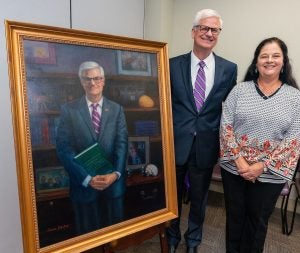 Dr. Mark Stacy and his wife, Dr. Tina Stacy, with portrait