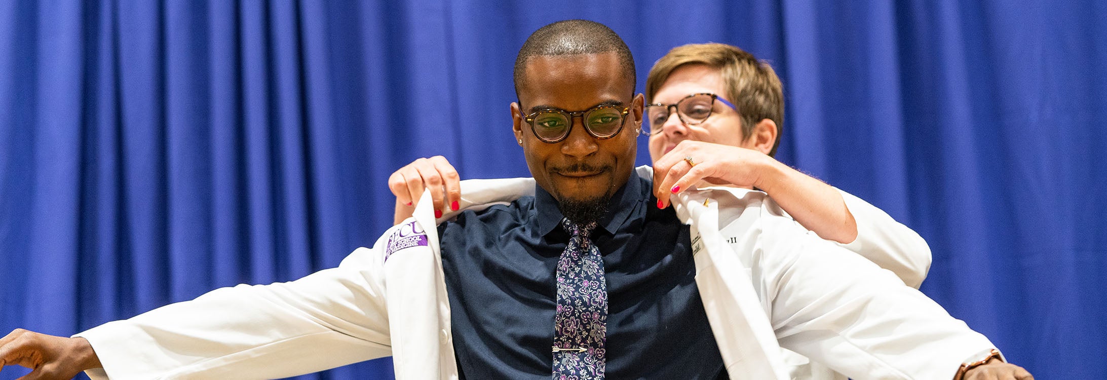 Kenneth Lowery II receives his coat during the Brody School of Medicine White Coat Ceremony for the Class of 2022. (Photo by Cliff Hollis)