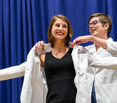 Veronica Lavelle receives her white coat. (Photo by Cliff Hollis)
