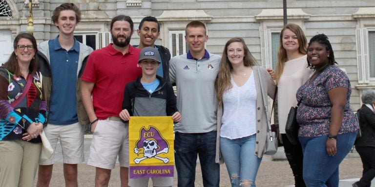 Six ECU students from the Department of Foreign Languages and Literatures and the Honors College visited the Madrid Royal Palace during their study abroad trip to Northern Spain. Seen here (left to right) are Dr. Katie Ford, Ethan Quinn, Dr. Todd Fraley and his son Keller (holding the ECU flag), Omar Sharaf, Austin Allen, Madigan Raper, Adelaide Robbins and Njisha Johnson.