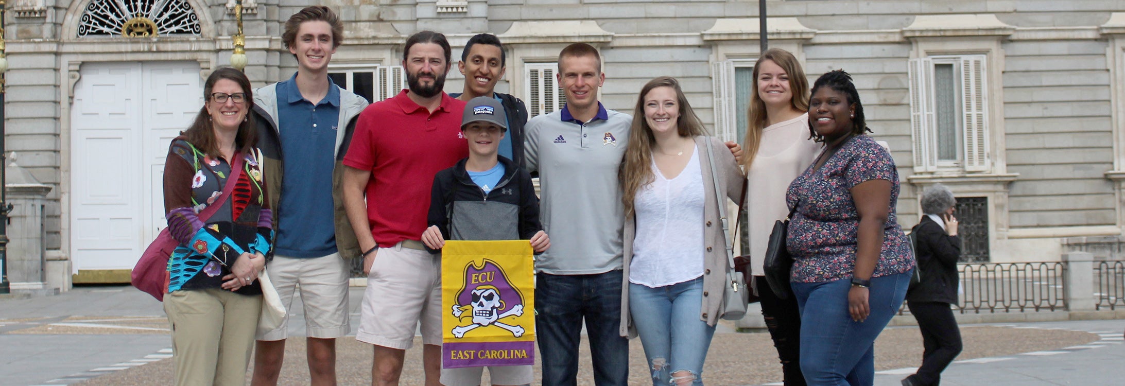 Six ECU students from the Department of Foreign Languages and Literatures and the Honors College visited the Madrid Royal Palace during their study abroad trip to Northern Spain. Seen here (left to right) are Dr. Katie Ford, Ethan Quinn, Dr. Todd Fraley and his son Keller (holding the ECU flag), Omar Sharaf, Austin Allen, Madigan Raper, Adelaide Robbins and Njisha Johnson.