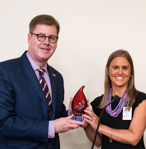 Chancellor Cecil Staton accepts an award from Kristen Sawyer, district manager for American Red Cross, recognizing ECU for its efforts in support of blood donation.