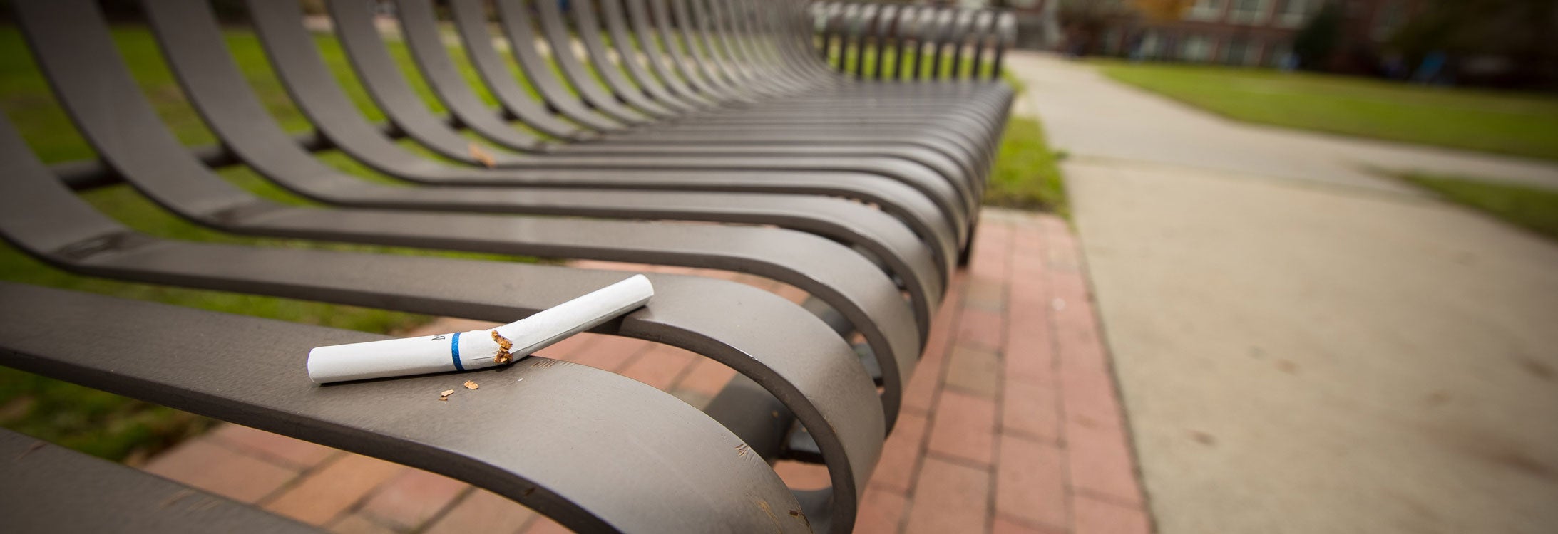 broken cigarette on a campus bench