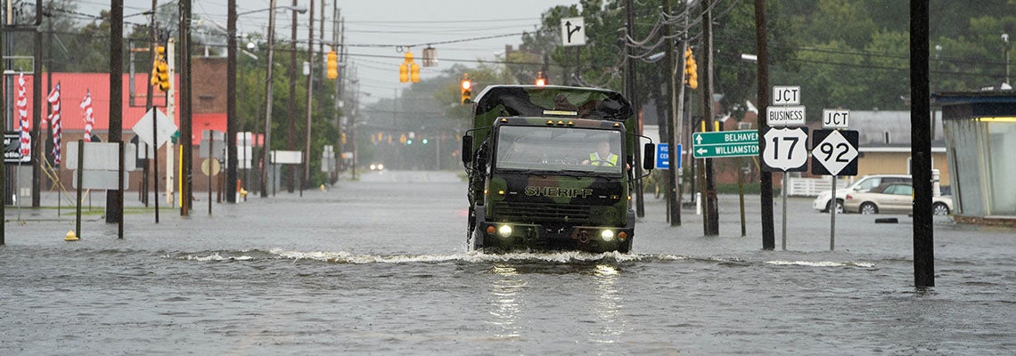 A sheriff's department truck drives through a flooded street Sept. 14 in Washington, N.C. 