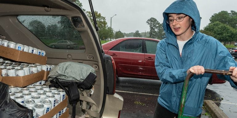 Holly Pittard, second-year Brody School of Medicine student, unloads water from an SUV at the Walter B. Jones Center in Pitt County. (ECU Photo by Cliff Hollis)