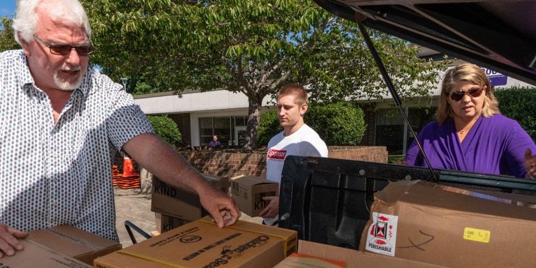 ECU alumnus Todd Burdick of Garner unloads food he brought Tuesday, Sept. 18, for university relief efforts as ECU junior Davis Basden and Sharon Paynter of ECU’s Division of Research, Economic Development and Engagement assist. Burdick works for a commercial food broker. (Photos by Cliff Hollis)