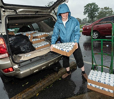 ECU medical student Holly Pittard unloads water at the Walter B. Jones Center in Greenville.