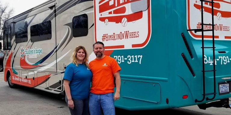 Ron Clements ’06 and his wife, Patti, in front of their RV.