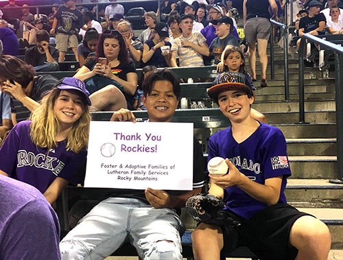 Children from the Lutheran Family Services Rocky Mountains attend a Colorado Rockies game in July 2018. 