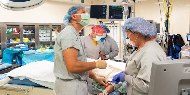 Dr. Bryan Ehlert, assistant professor in the Division of Vascular Surgery at ECU’s Brody School of Medicine, performs a TCAR procedure at the East Carolina Heart Institute at Vidant Medical Center. (Photos by Cliff Hollis)