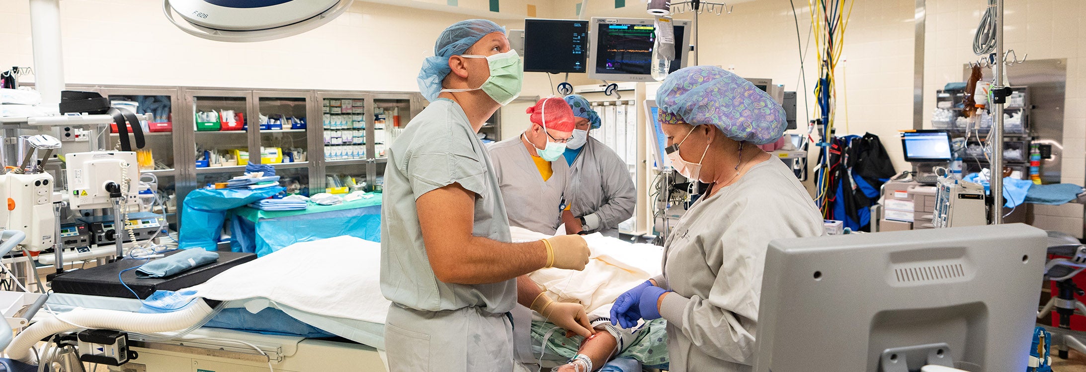 Dr. Bryan Ehlert, assistant professor in the Division of Vascular Surgery at ECU’s Brody School of Medicine, performs a TCAR procedure at the East Carolina Heart Institute at Vidant Medical Center. (Photos by Cliff Hollis)