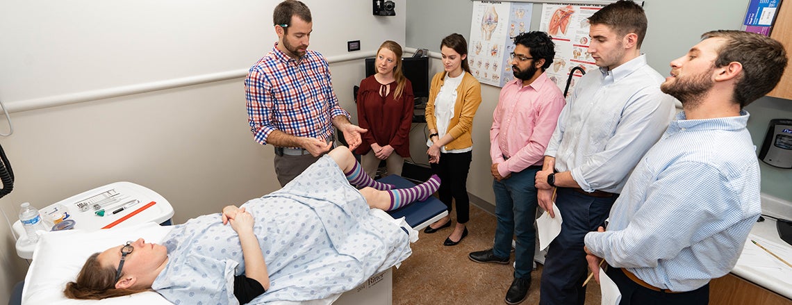 Dr. Evan Lutz, ECU clinical assistant professor of family medicine and interim director of the sports medicine division, instructs second-year medical students.