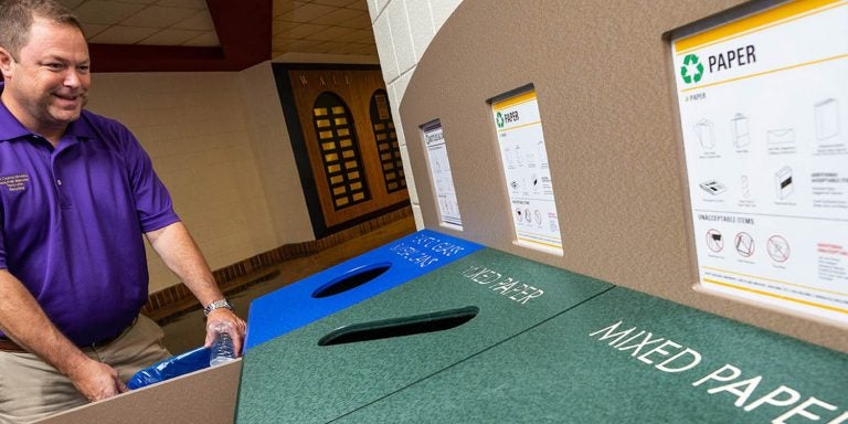 ECU recycling coordinator Terry Little empties a bin in Bate. (Photos by Cliff Hollis)