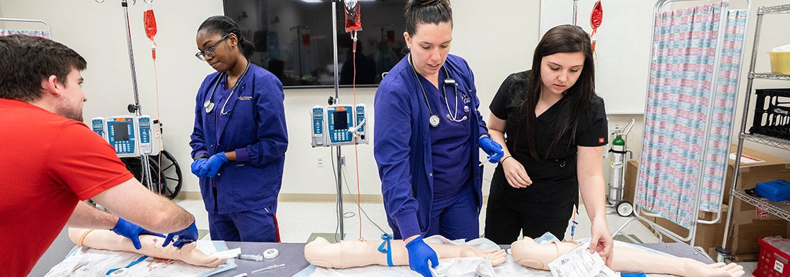 Nursing students show medical students how to insert a peripheral IV in the hemmorrhage management portion of the disaster simulation.