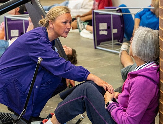 Nursing student Summer Long assesses a victim during the triage portion of the simulation.