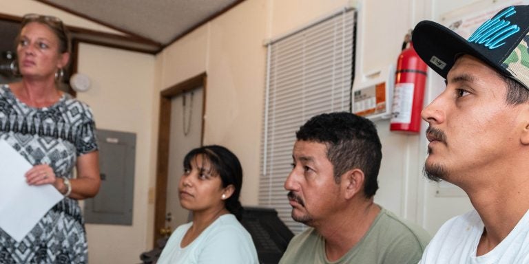 ECU’s Mary Tucker-McLaughlin, left, talks with migrant workers about coping with stress during a focus group held at an Edgecombe County farm in September.