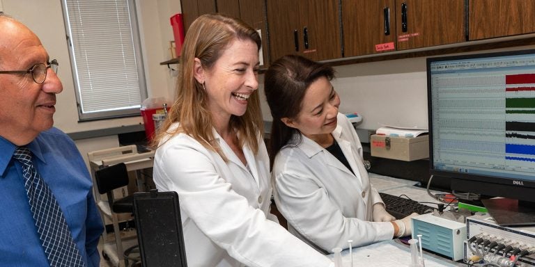 Dr. Abdel Abdel-Rahman, left, researches the effects of alcohol on cardiac function with doctoral candidate Korin Leffler, center, and lab manager Kui Sun. (Photos by Cliff Hollis)