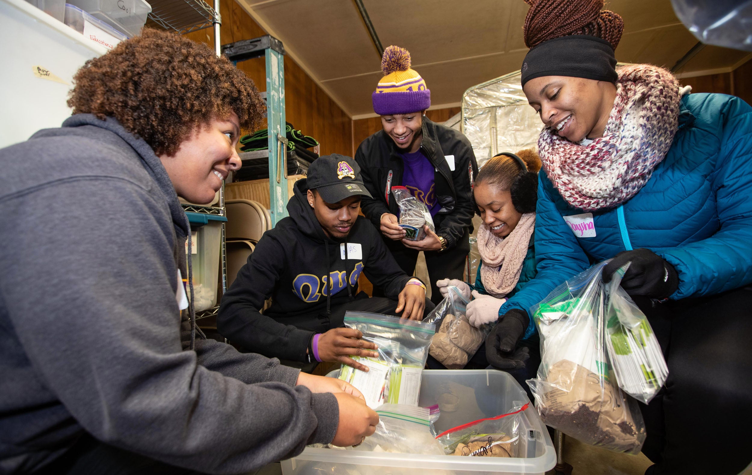 Students organize seed packets at the Making Pitt Fit Community Garden. 