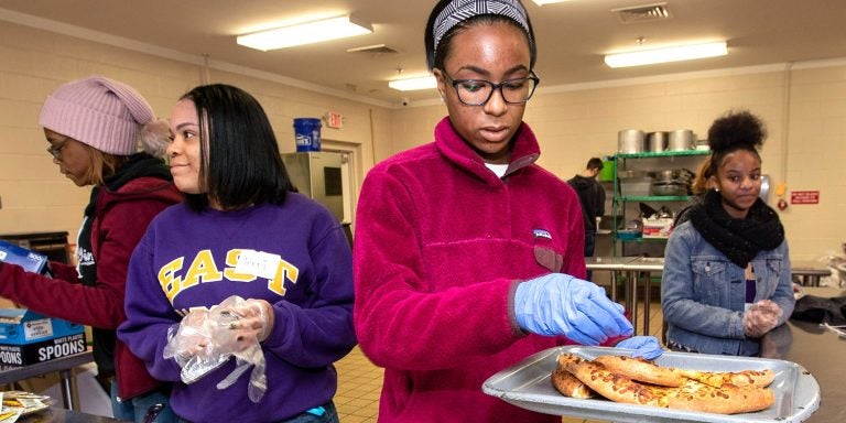 Members of ECU’s Black Student Union serve lunch at the Community Crossroads Center.
