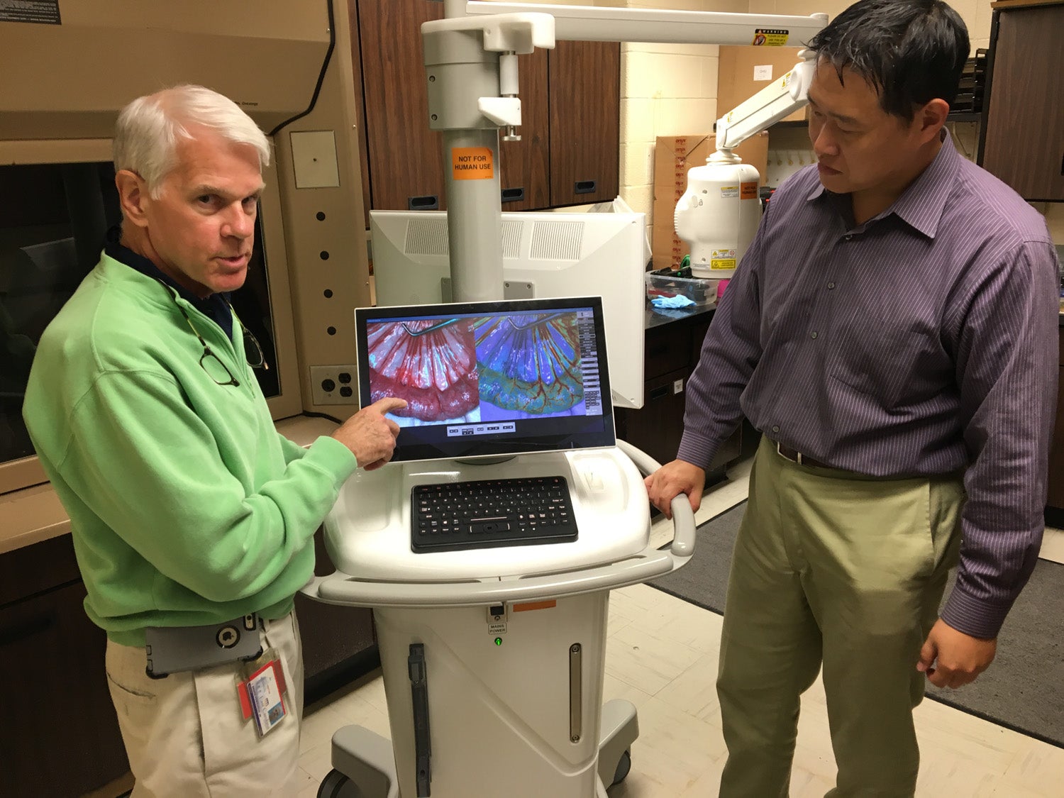 Dr. T. Bruce Ferguson, left, Dr. Cheng Chen and Dr. Kenneth Jacobs (not pictured) were issued a patent that introduces innovative technology that allows surgeons to observe blood flow during surgical procedures. 