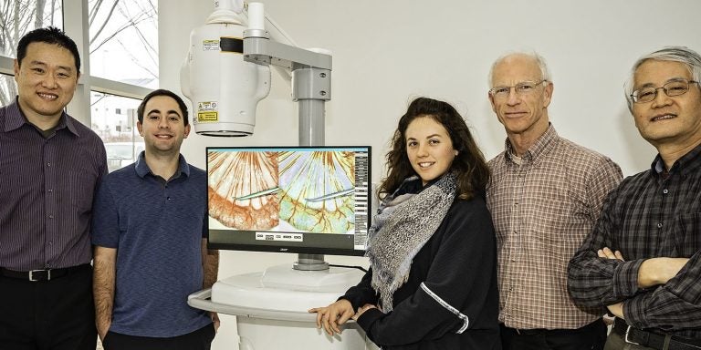 Dr. Cheng Chen, left, and Dr. Kenneth Jacobs, second from right, are part of a trio of ECU researchers recognized last year for advancements in medical imaging.