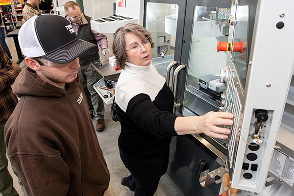 Industrial Engineering Technology professor Dr. Sharon Rouse explains the controls of one of the Haas CNC machines during a class in the high bay at ECU’s Science and Technology Building. (Photo by Rhett Butler)