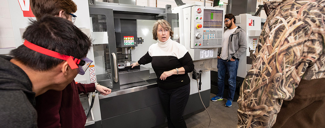 Industrial Engineering Technology professor Dr. Sharon Rouse demonstrates the use of the Haas CNC machines to students. (Photo by Rhett Butler)