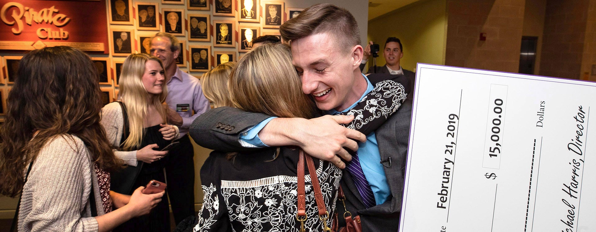 Steven Lipscomb shares a hug with his mother after winning the Pirate Entrepreneurship Challenge for an app he developed with co-founder Camden Bathras.