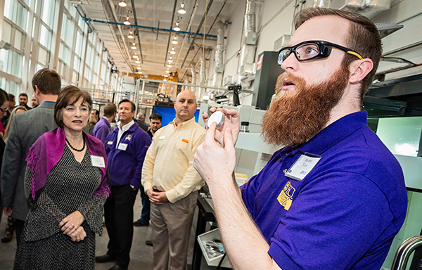 Sean Wear, a junior in the technology systems program, demonstrates the operation of a CNC mill. (Photo by Cliff Hollis)