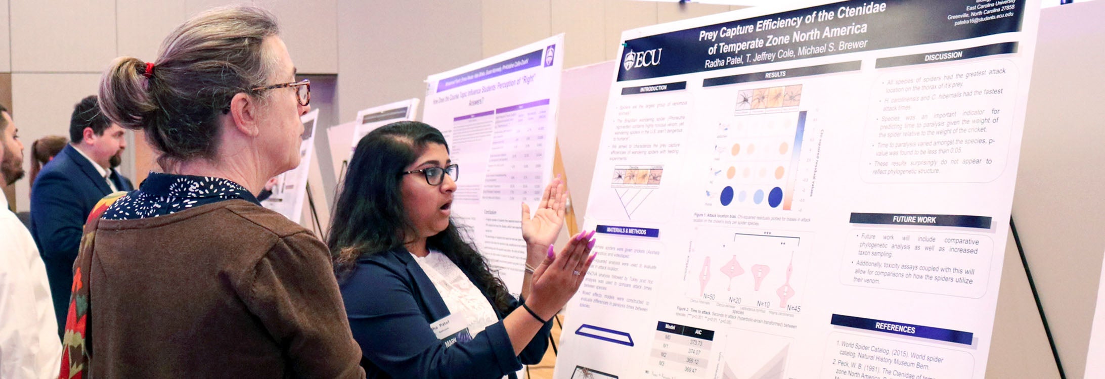 Undergraduate researcher Radha Patel shares her work with a judge at East Carolina University’s 13th annual Research and Creative Achievement Week. A record number of undergraduate students presented at this year’s event. (Photo by Matt Smith)