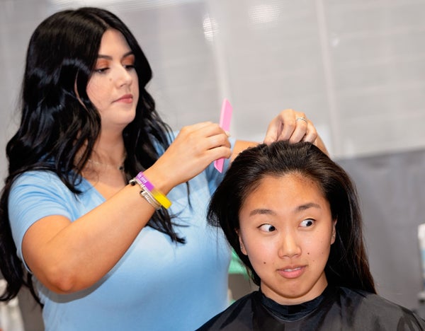 Jenny Song makes a face waiting to get her hair cut during the Pirates Vs. Cancer event. 