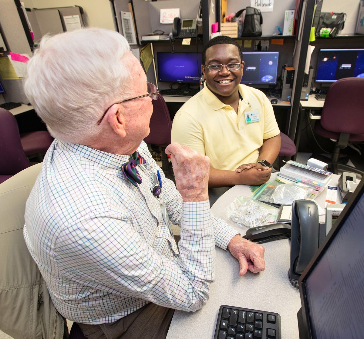 Denning smiles as he talks with Dr. Tom Irons at ECU Physicians Pediatric Outpatient Center.