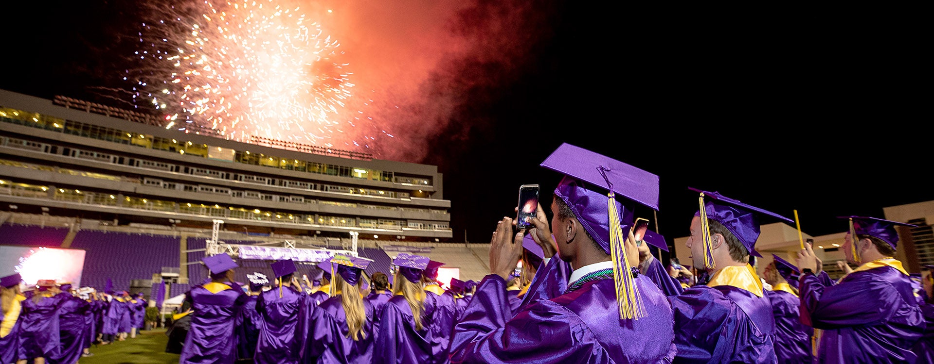 Spring graduates captured the view from the field as fireworks erupted behind Dowdy-Ficklen’s southside. 