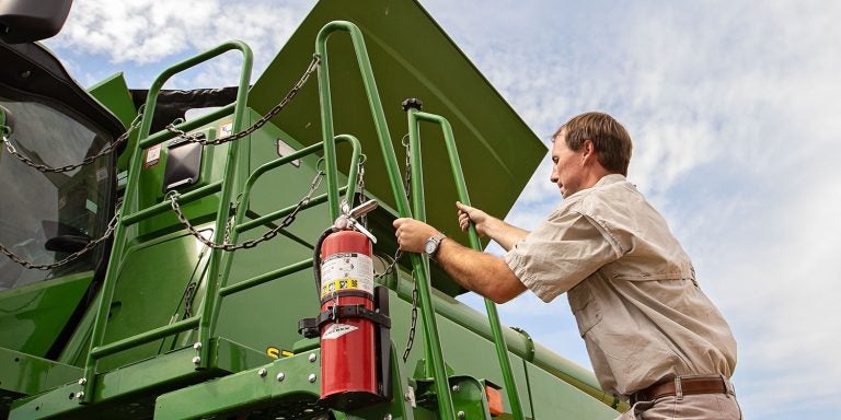 Third-generation farmer Archie Griffin operates a combine on his family’s farm in Washington, North Carolina.