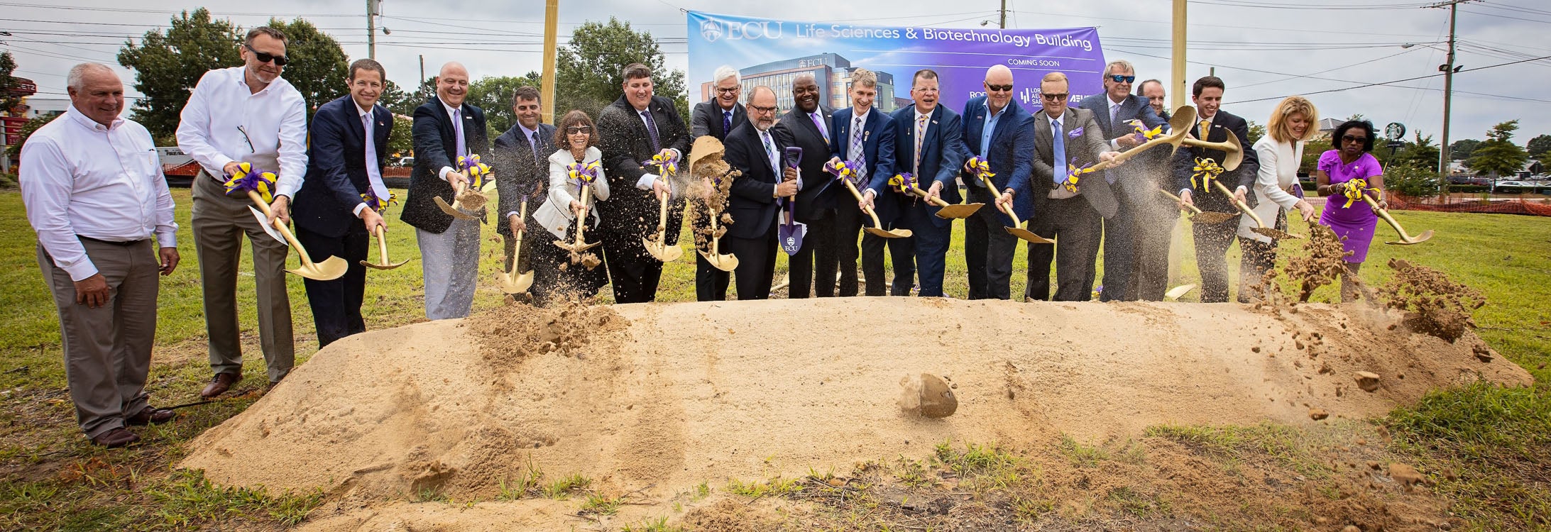 ECU officials and representatives from the design and construction firms responsible for the Life Sciences and Biotechnology Building break ground on the $90 million project. (Photos by Cliff Hollis)