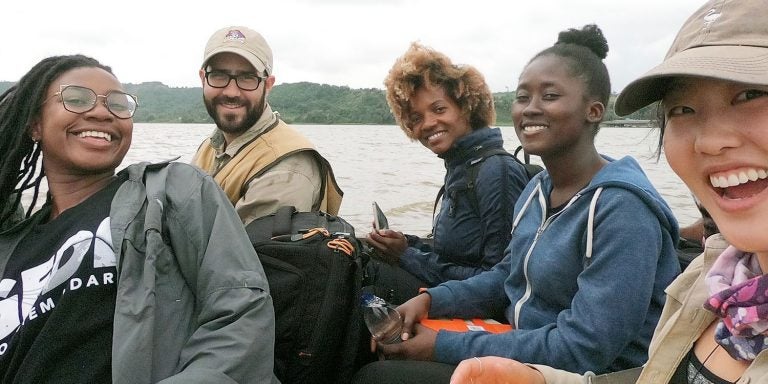 ECU Assistant Professor David Lagomasino, center, travels on a boat with students and research colleagues in West Africa. Lagomasino visited the region in August to study the coastal ecosystem which resembles North Carolina’s coast.