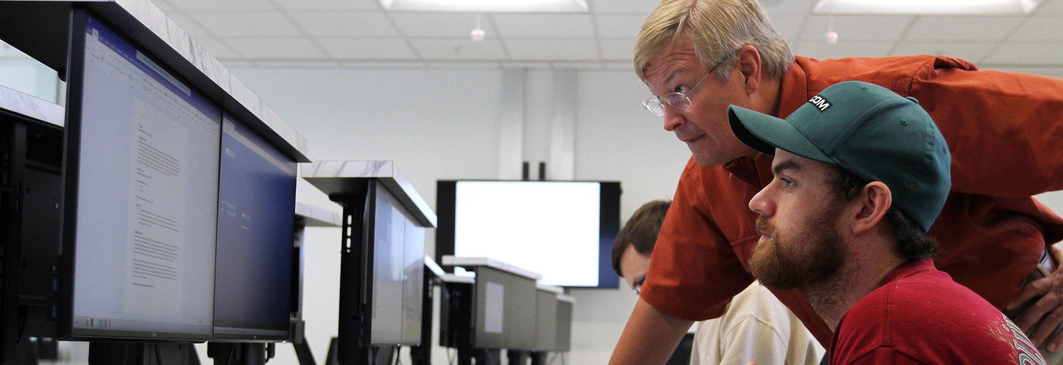 Dr. Charles Lesko instructs Nicholas Hempenius, a second-year graduate student from Jacksonville, in the new cybersecurity lab in the Science and Technology Building. The lab supports about 150 students with concentrations in cybersecurity. (Photos by Ken Buday)