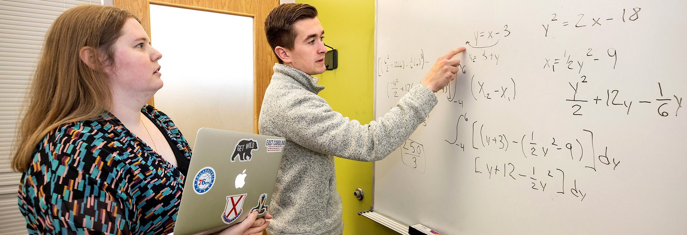 Amber Arnold, assistant director of student success in the Pirate Academic Success Center, works with ECU student Nolan McDonald on an assignment. Photo by Rhett Butler.