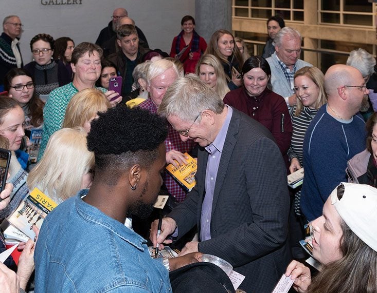 Rick Steves signs autographs following his talk at the Main Campus Student Center. Contributed photo by Rob Taylor.