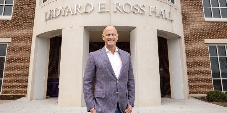 Greenville orthodontist and ECU donor Dr. Dennis Ross stands in front of the School of Dental Medicine, named after his father, Ledyard.<br>(Photo by Rhett Butler | Video by Rich Klindworth)
