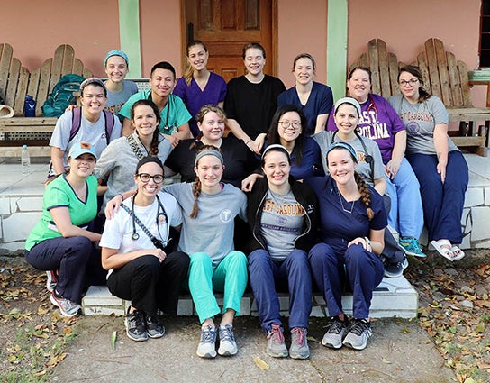 Kim Stokes poses for a photo with her students during a trip to Honduras. 