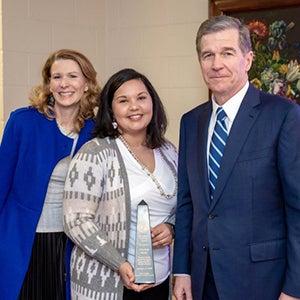 Aleshia Hunt, center, poses with Gov. Roy Cooper and Kristin Cooper, First Lady of North Carolina.