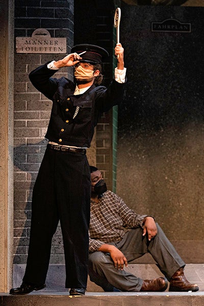 The station master is one of 40 characters in ECU’s production of “The Visit.”