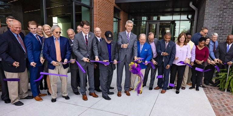 Chancellor Philip Rogers, ECU Board of Trustees members and other dignitaries cut the ribbon to officially open the new Life Sciences and Biotechnology Building.